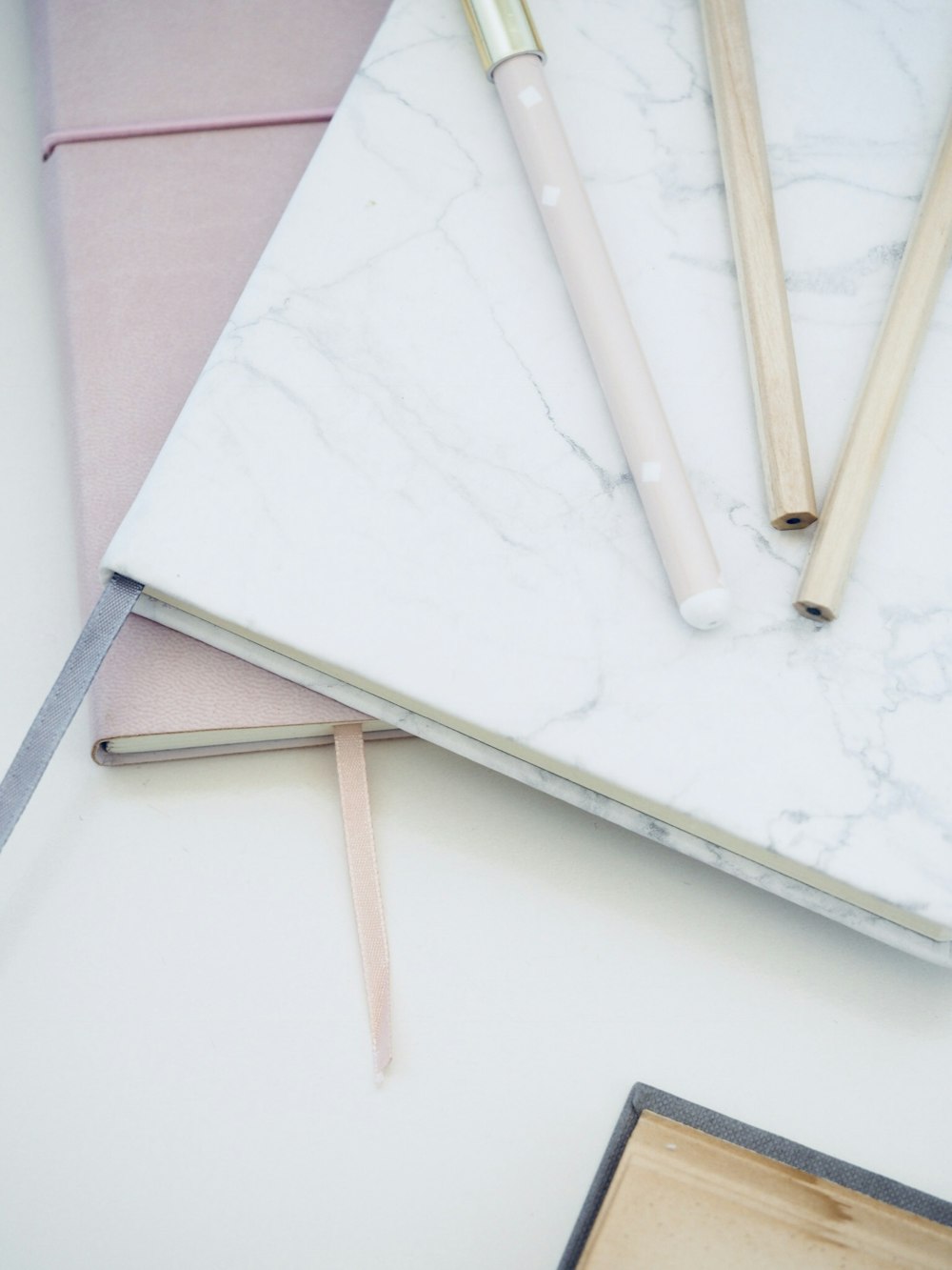 a marbled notebook with a pen and a pencil on top of it