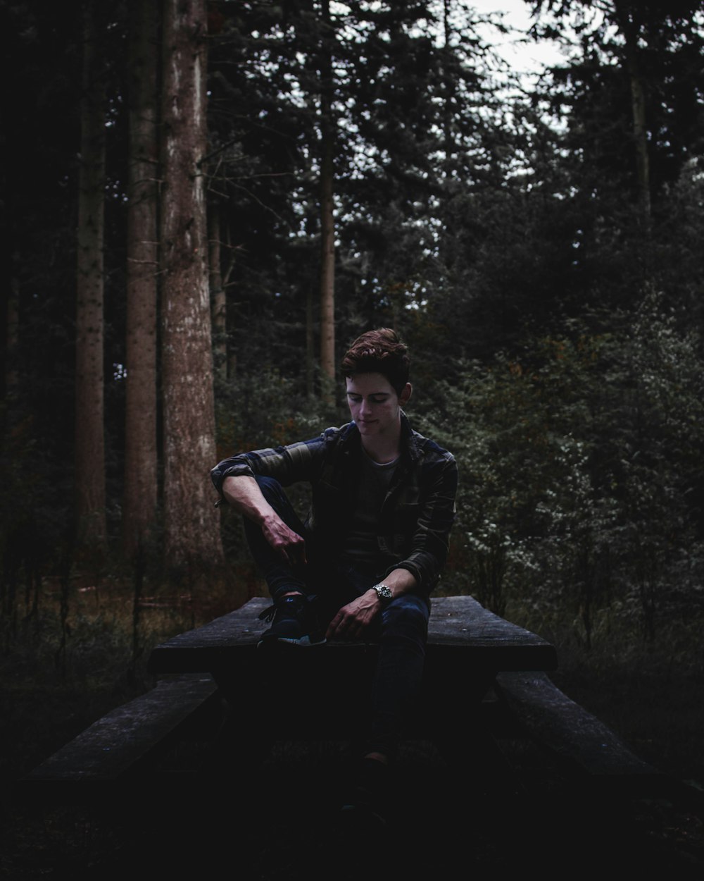 man sitting on concrete chair