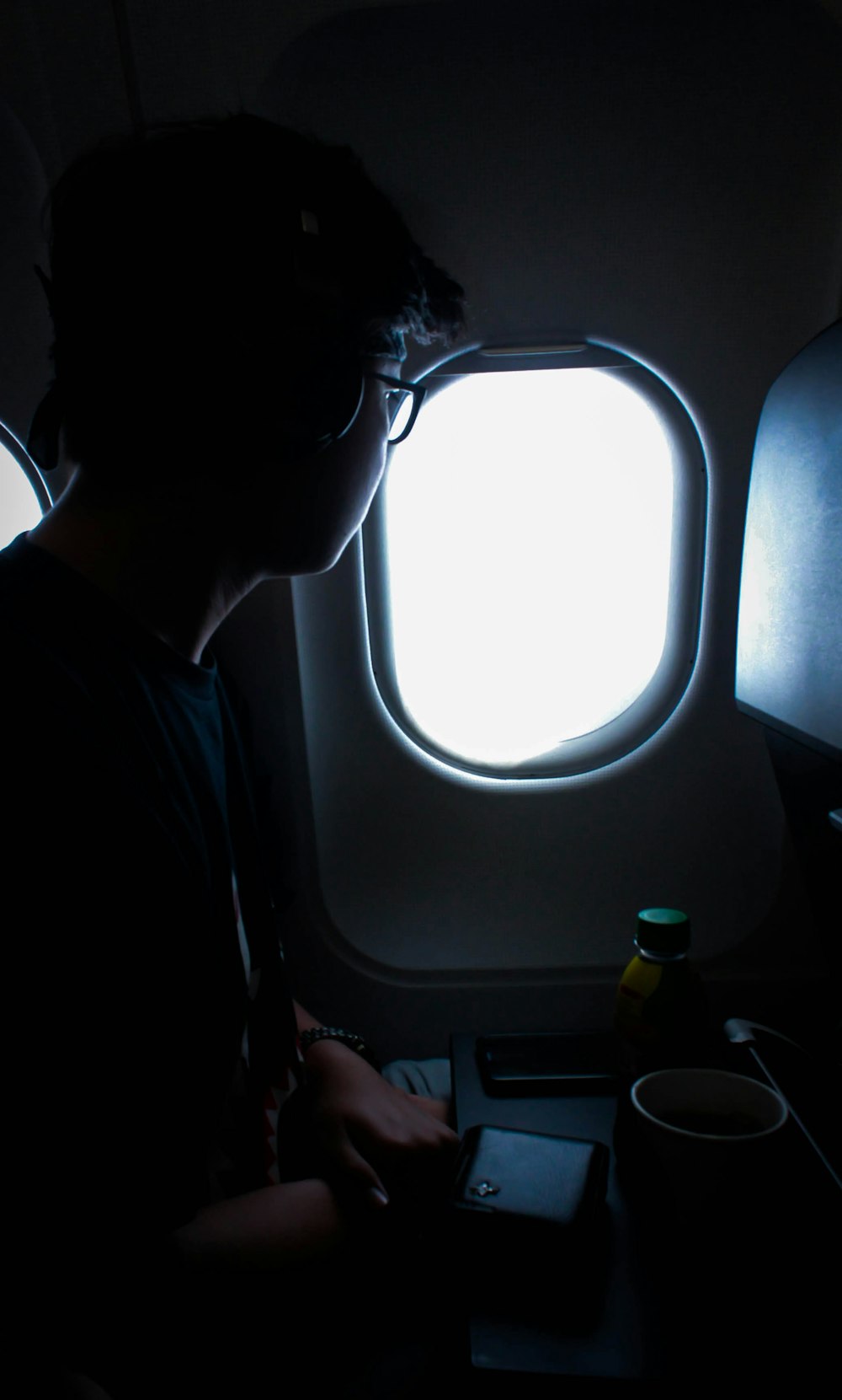 person sitting near plane window