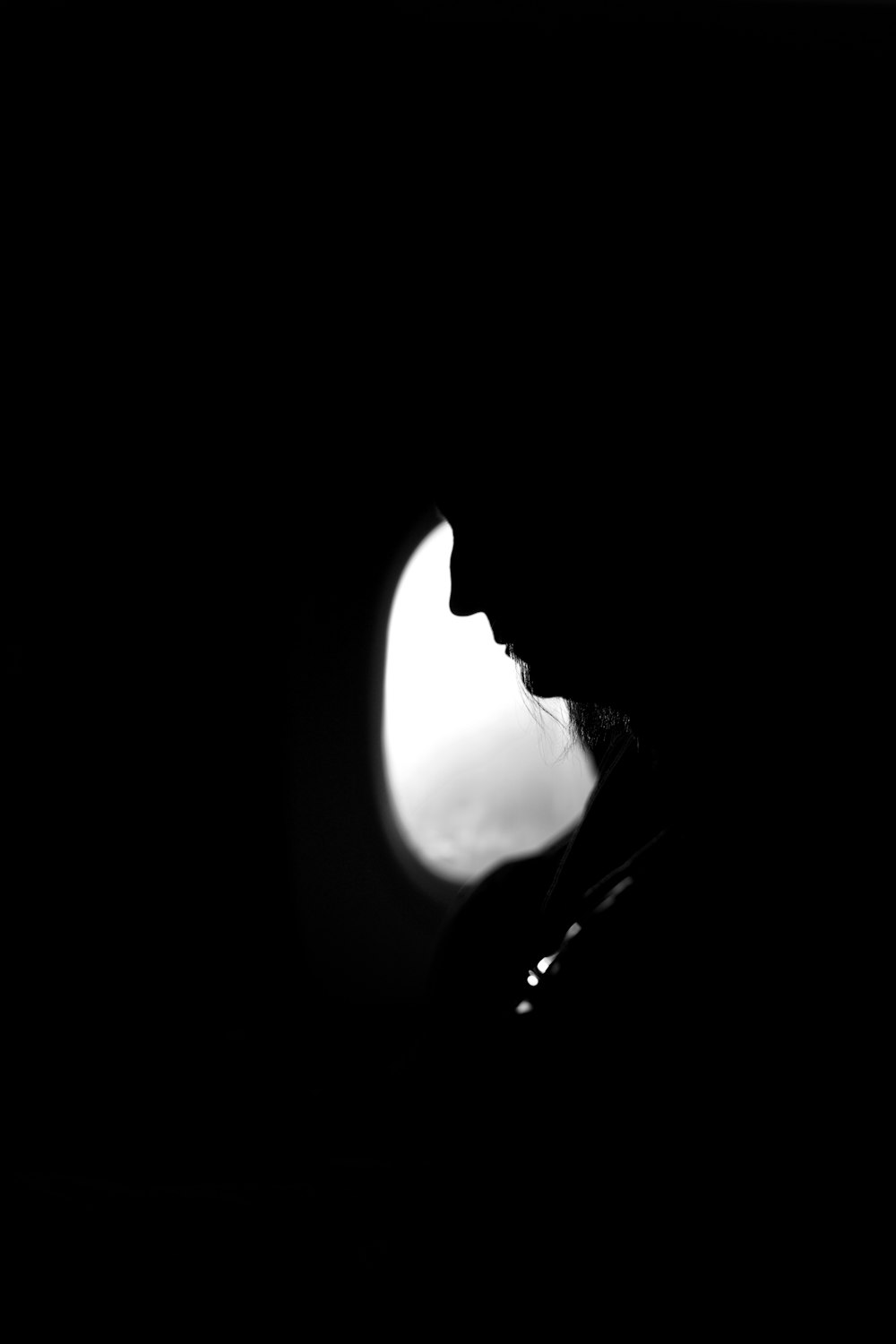 a silhouette of a person in a dark room