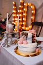2-tier cake on table beside candles
