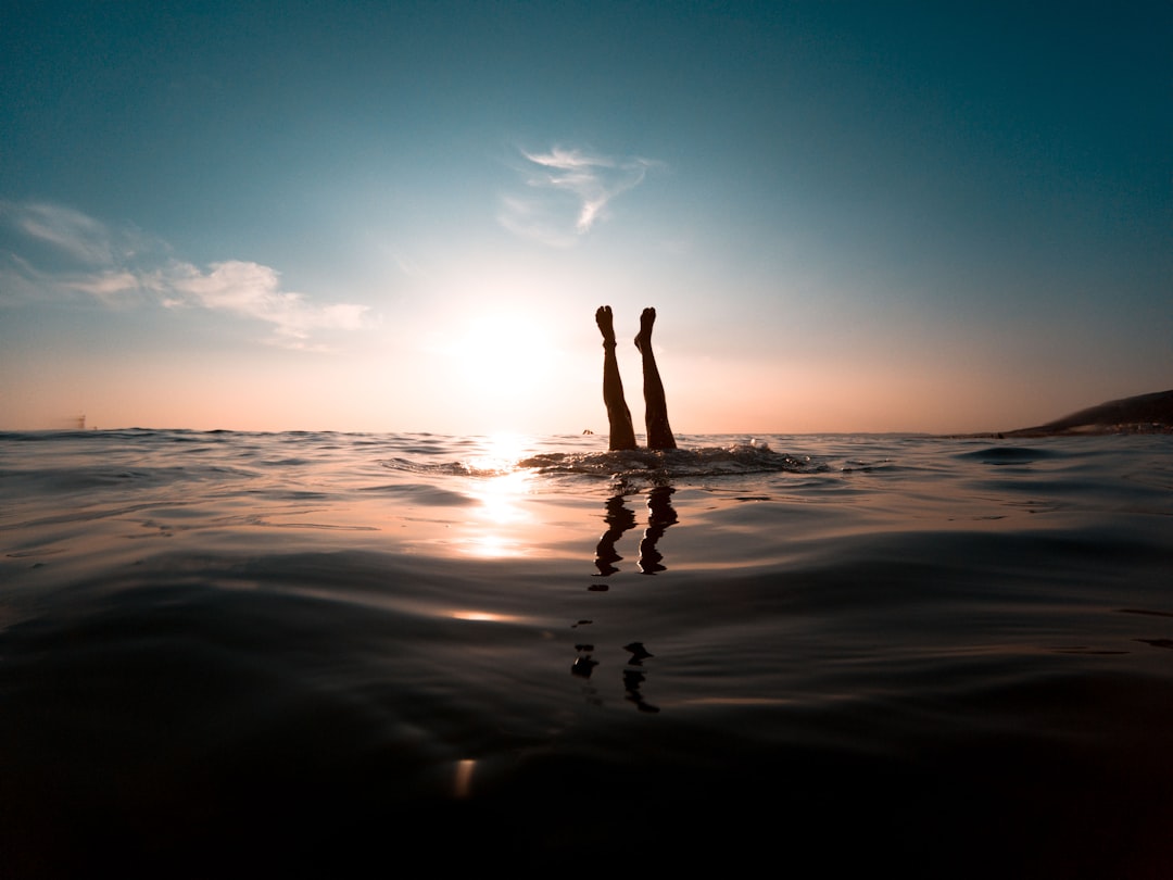 person diving in body of water,
