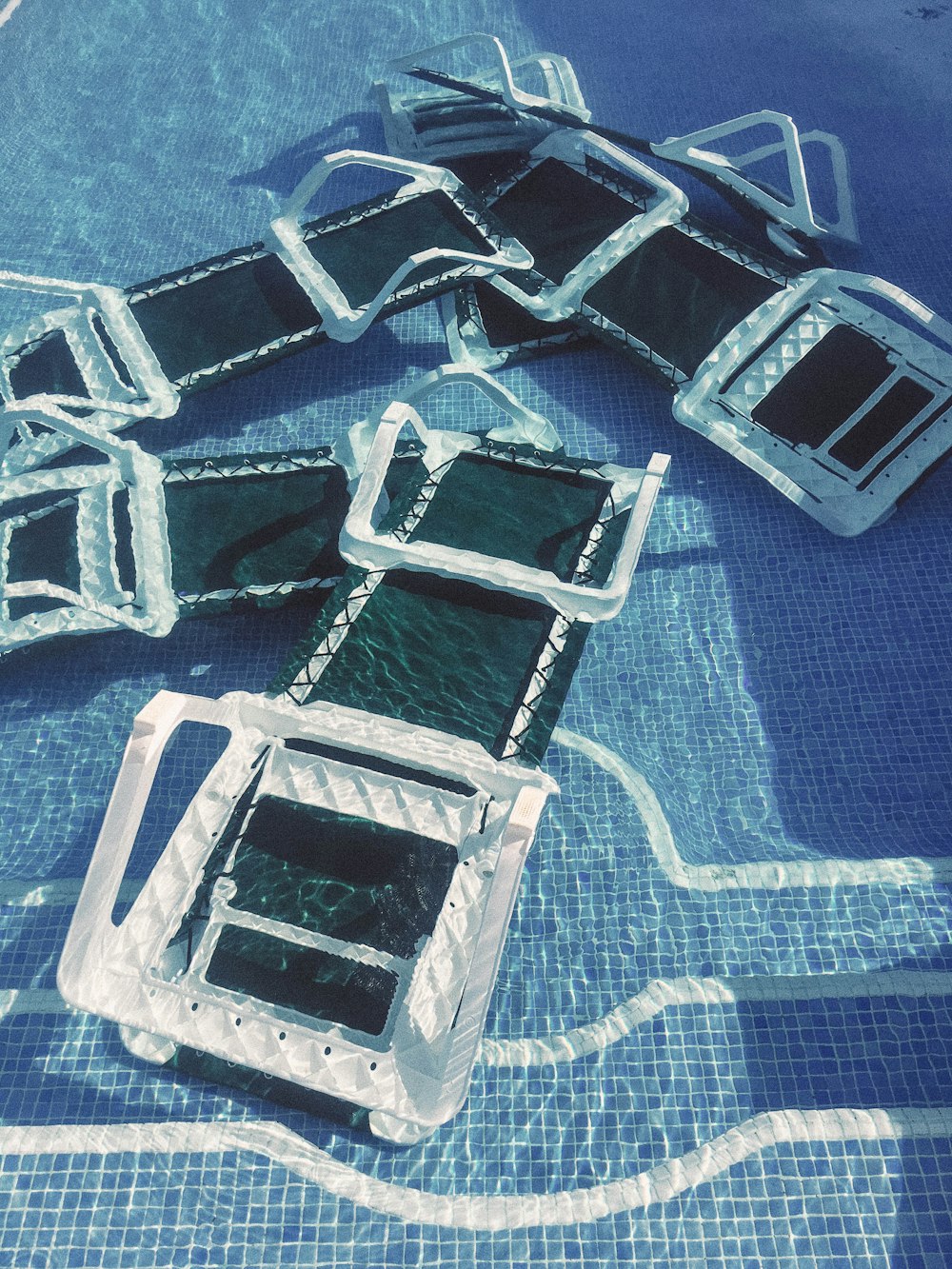 black-and-white inflatable beds on pool