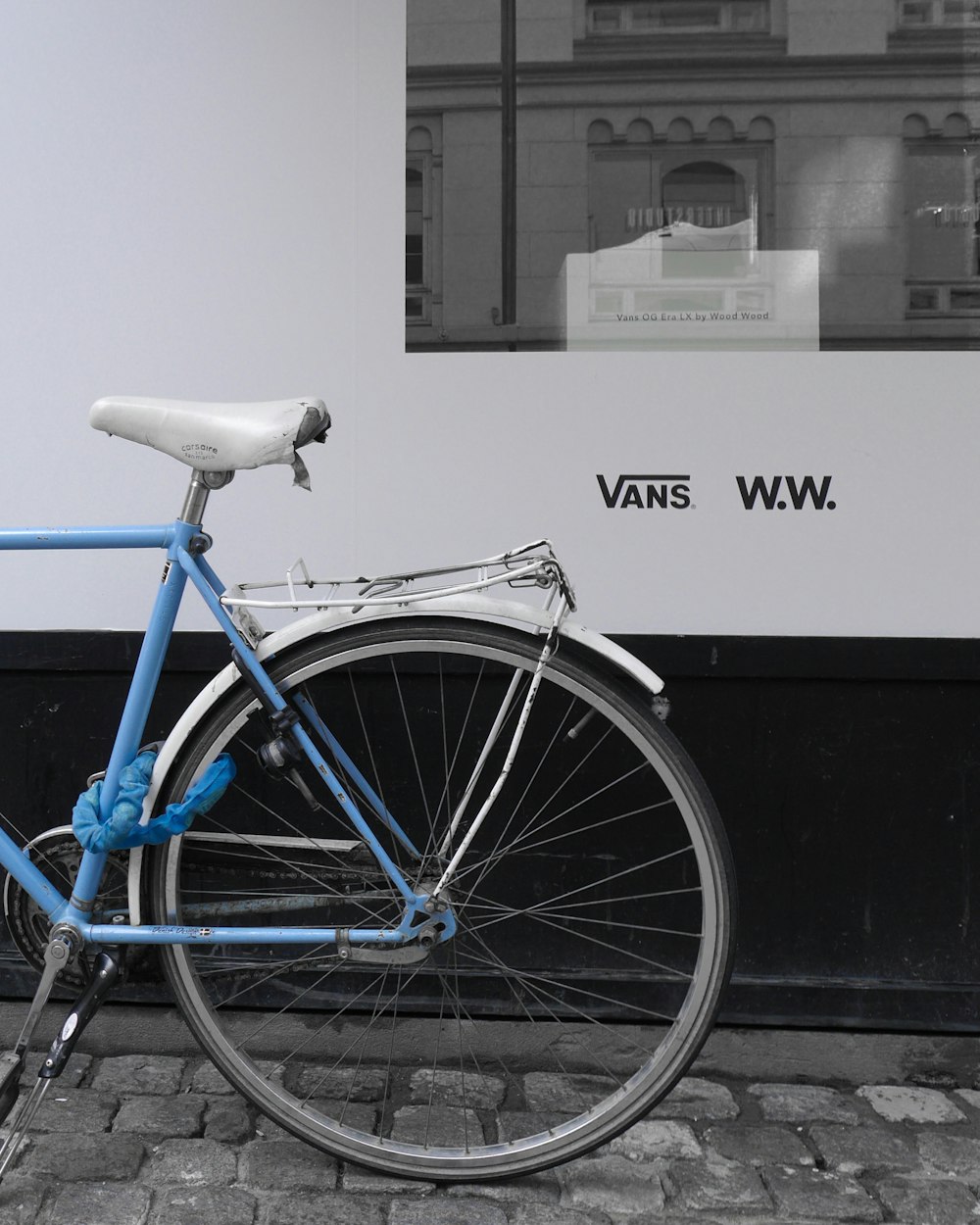 blue cruiser bicycle in front of window