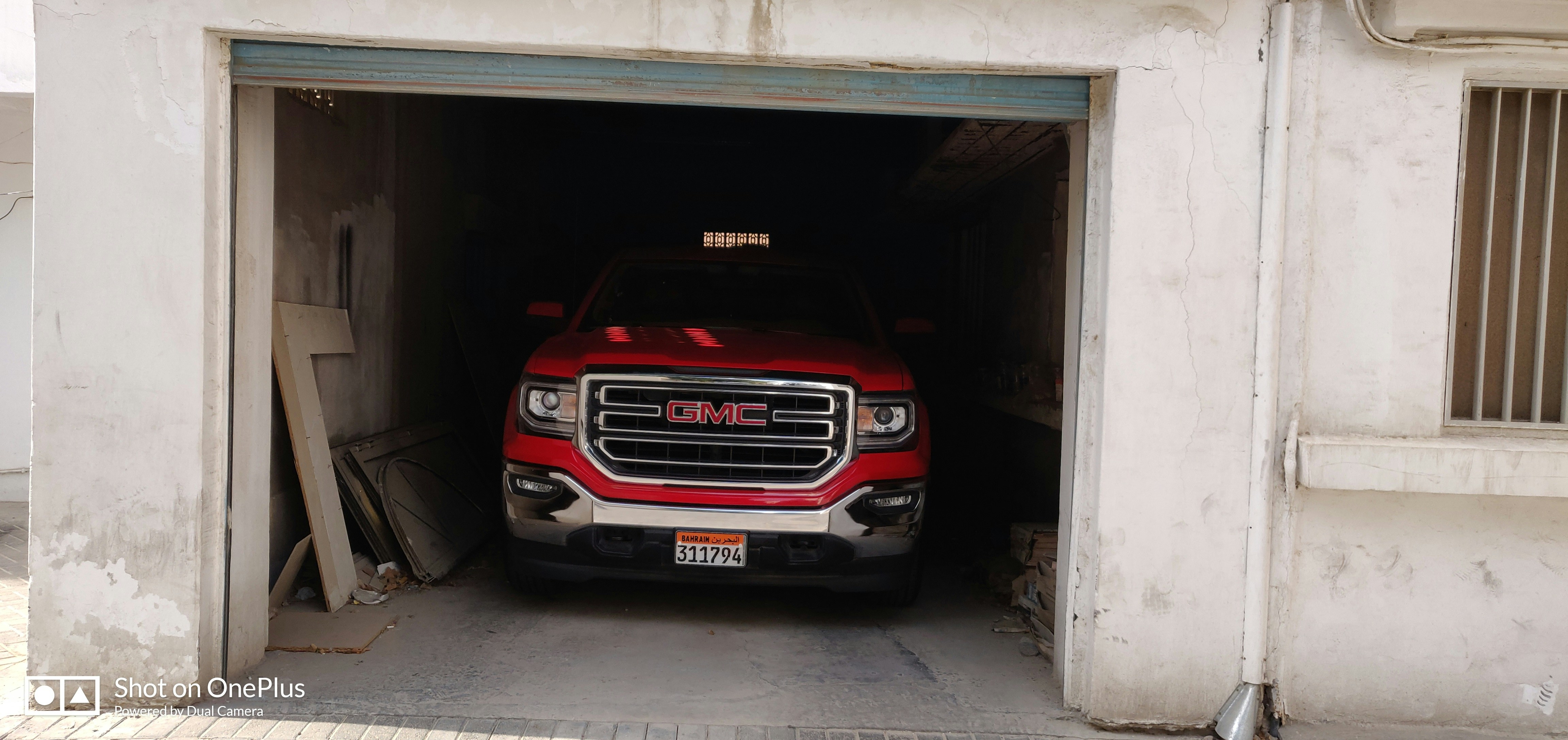 Heavy-duty truck performance exhaust, dark atmospheric garage, deep shadows