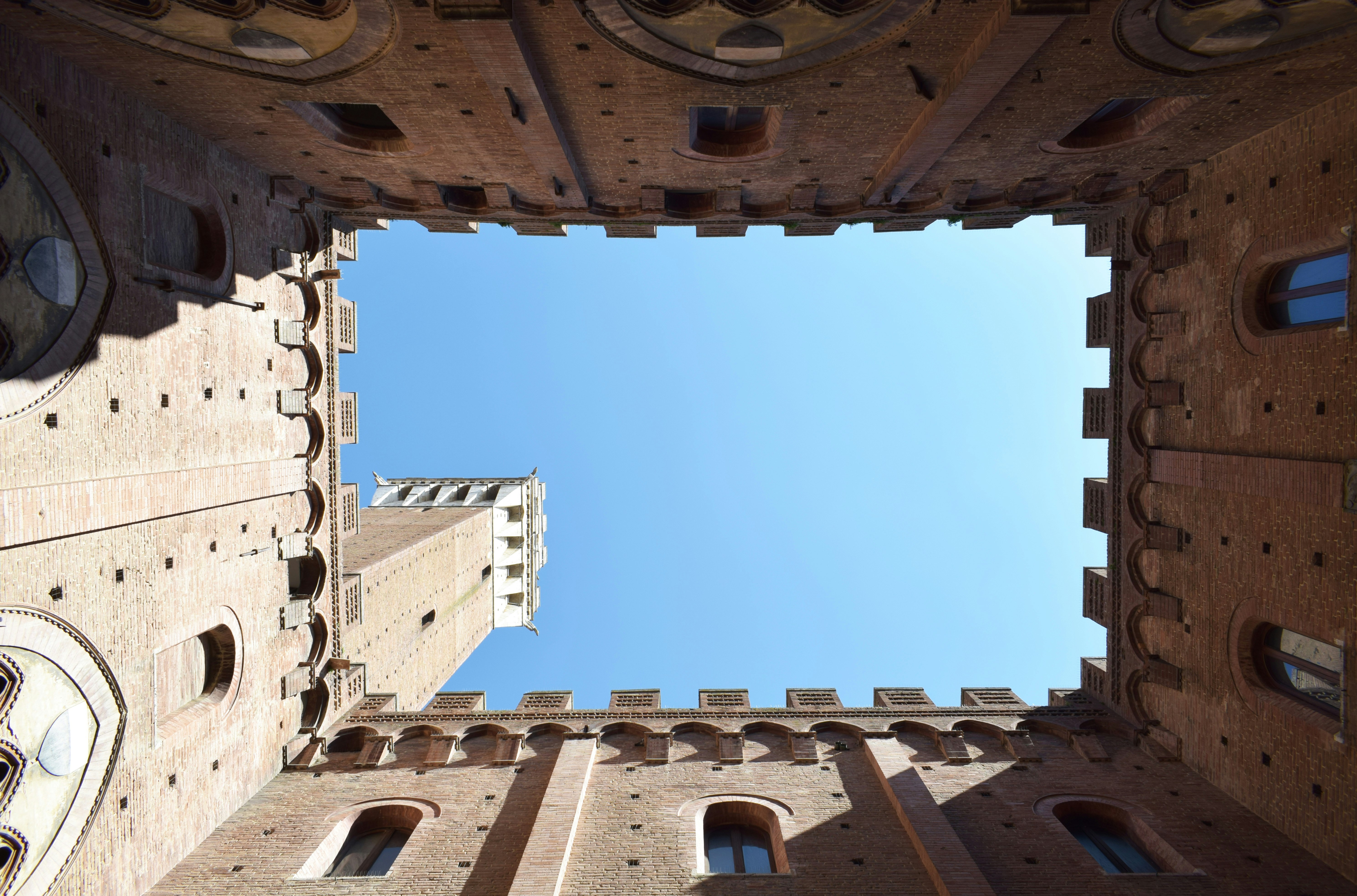 brown castle building center court under clear blue sky