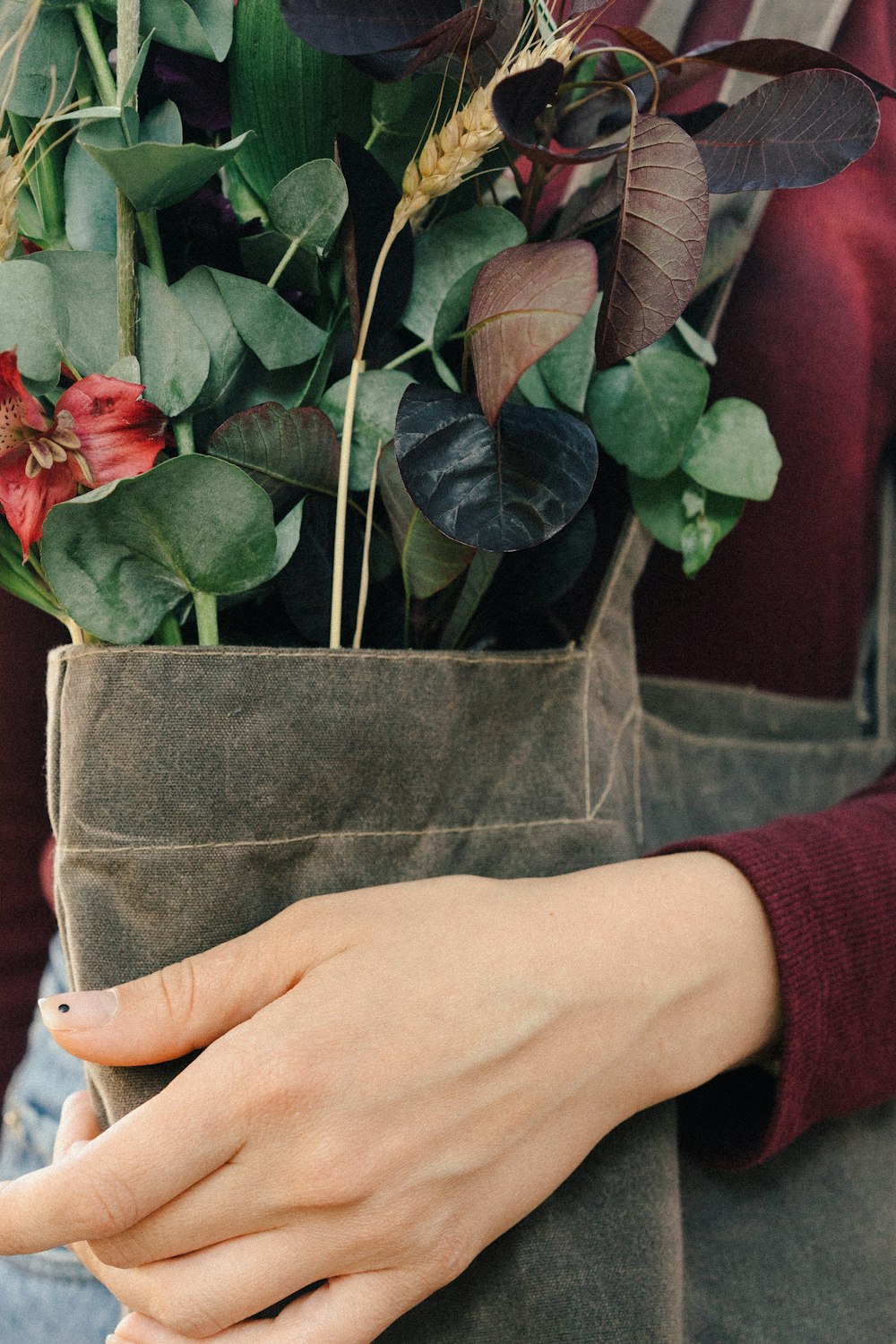 woman carrying brown tote bag with flower