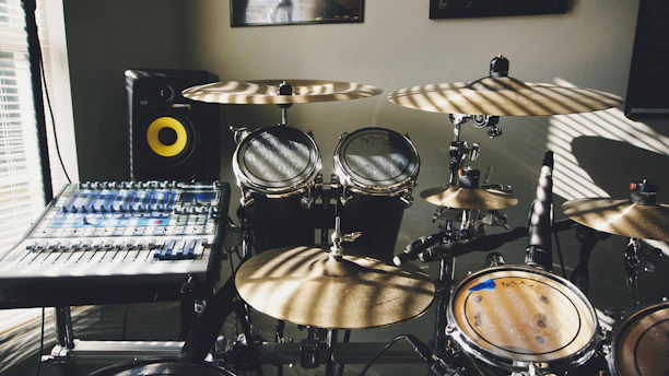 Photo of Matthew Sun in the acoustic tuning lab, surrounded by audio equipment.