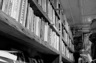 A nostalgic black and white photo of a father and son in a bookstore.
