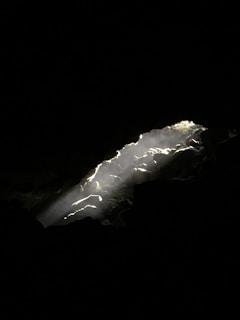 Sunlight illuminating crystalline silver deposits within a mine shaft.