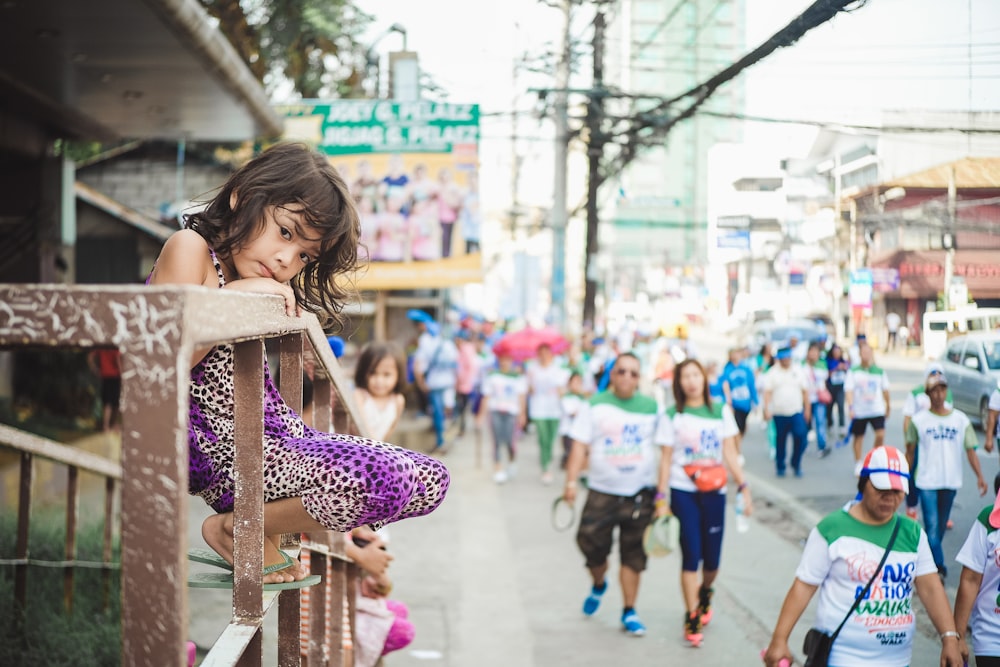 girl sitting on stair railings