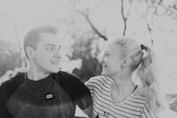 A warm photo of an African American man and woman sharing a healthy meal outdoors, smiling and connecting.