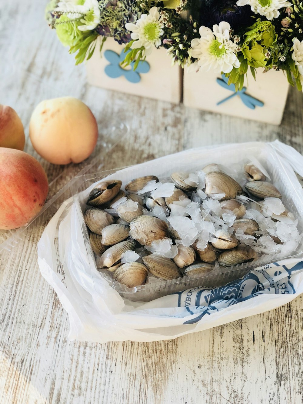 seashells on basket near peach fruits