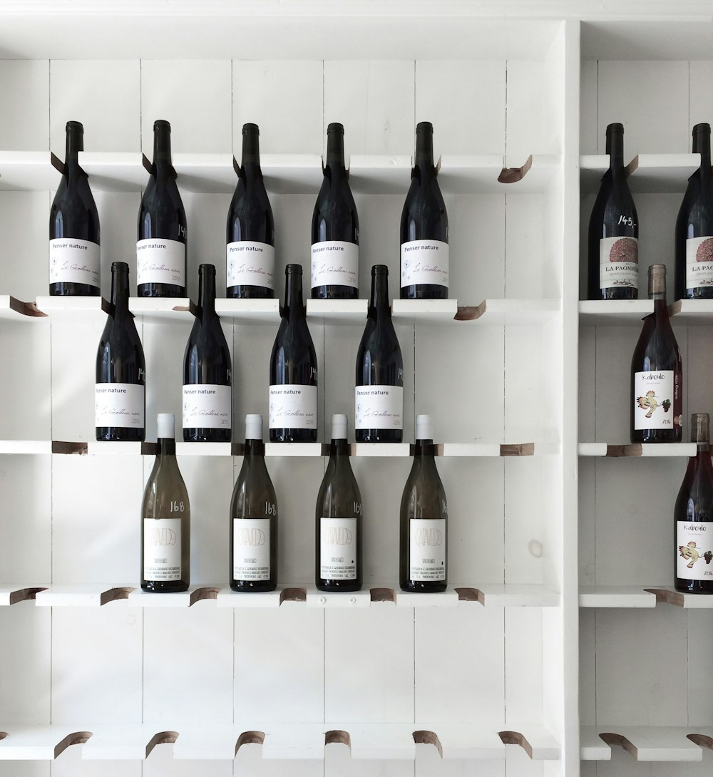 wine bottle on white wooden shelf