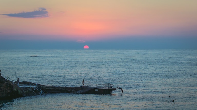 Sunset view from the dive center with divers relaxing after a day underwater.