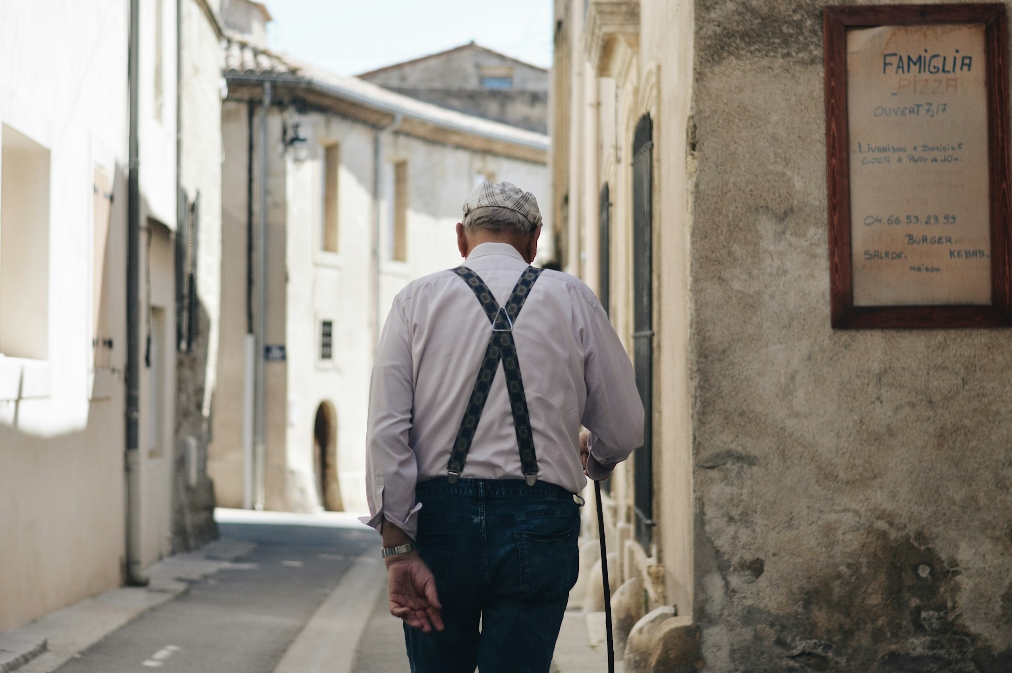 The back of the old man walking in the street