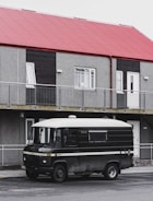 A mobile locksmith van parked in front of a house.