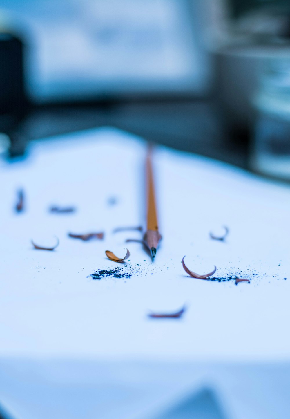 a pencil laying on top of a white table