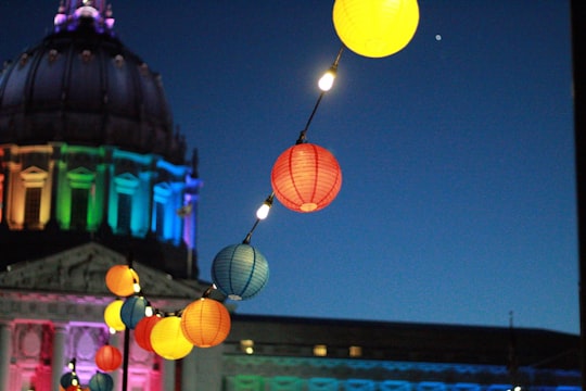 line of lighted lanterns in front of dome building during nighttime in San Francisco United States