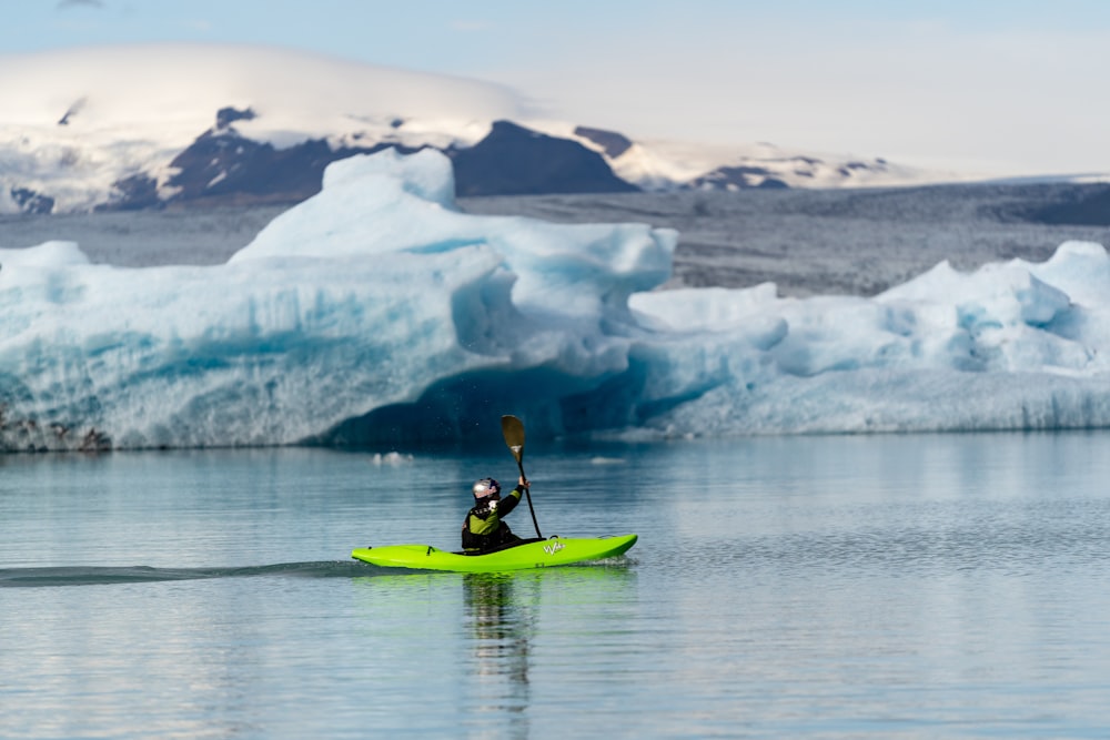 person paddling boat on body of water