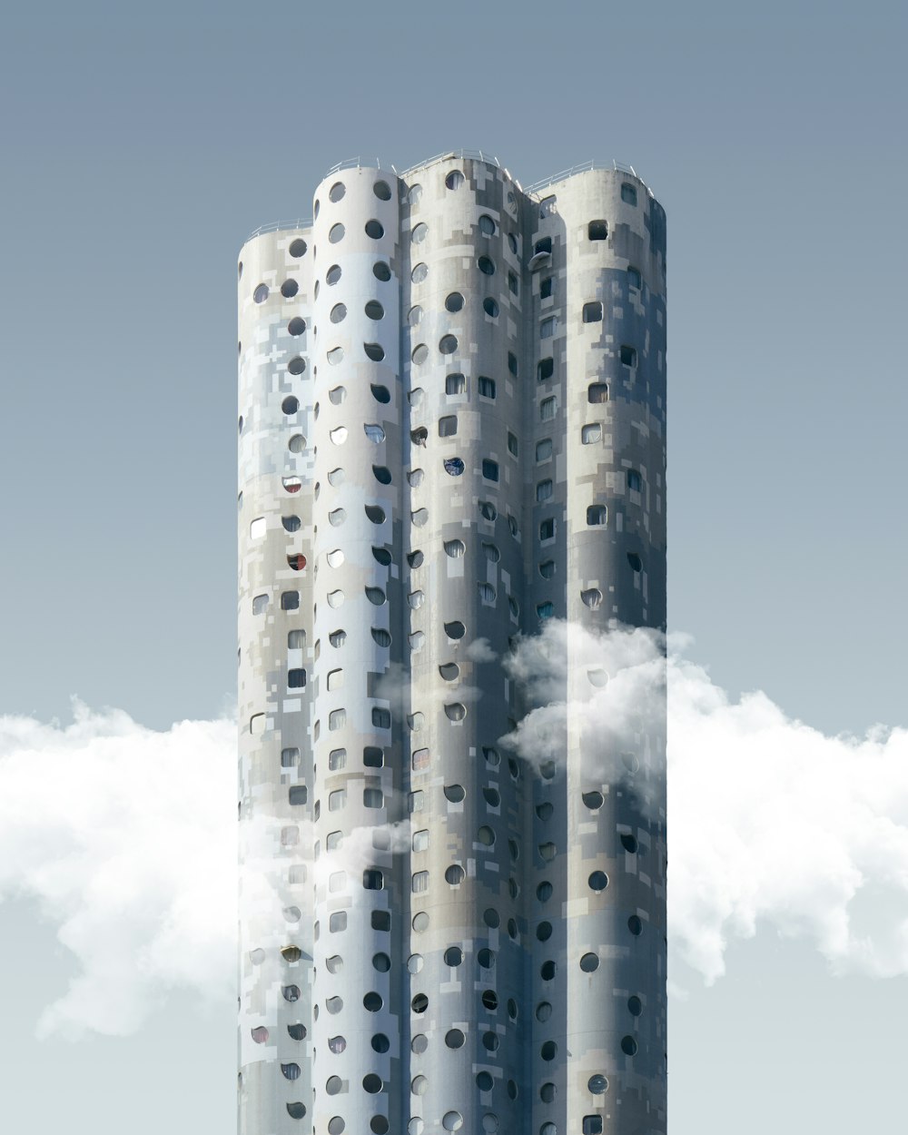 edifício cinza com nuvens