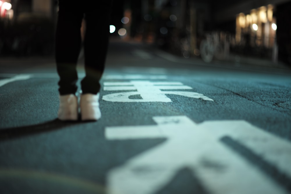 person standing on gray concrete road