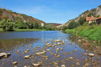 A peaceful river flowing through vibrant natural landscapes near residential lots.