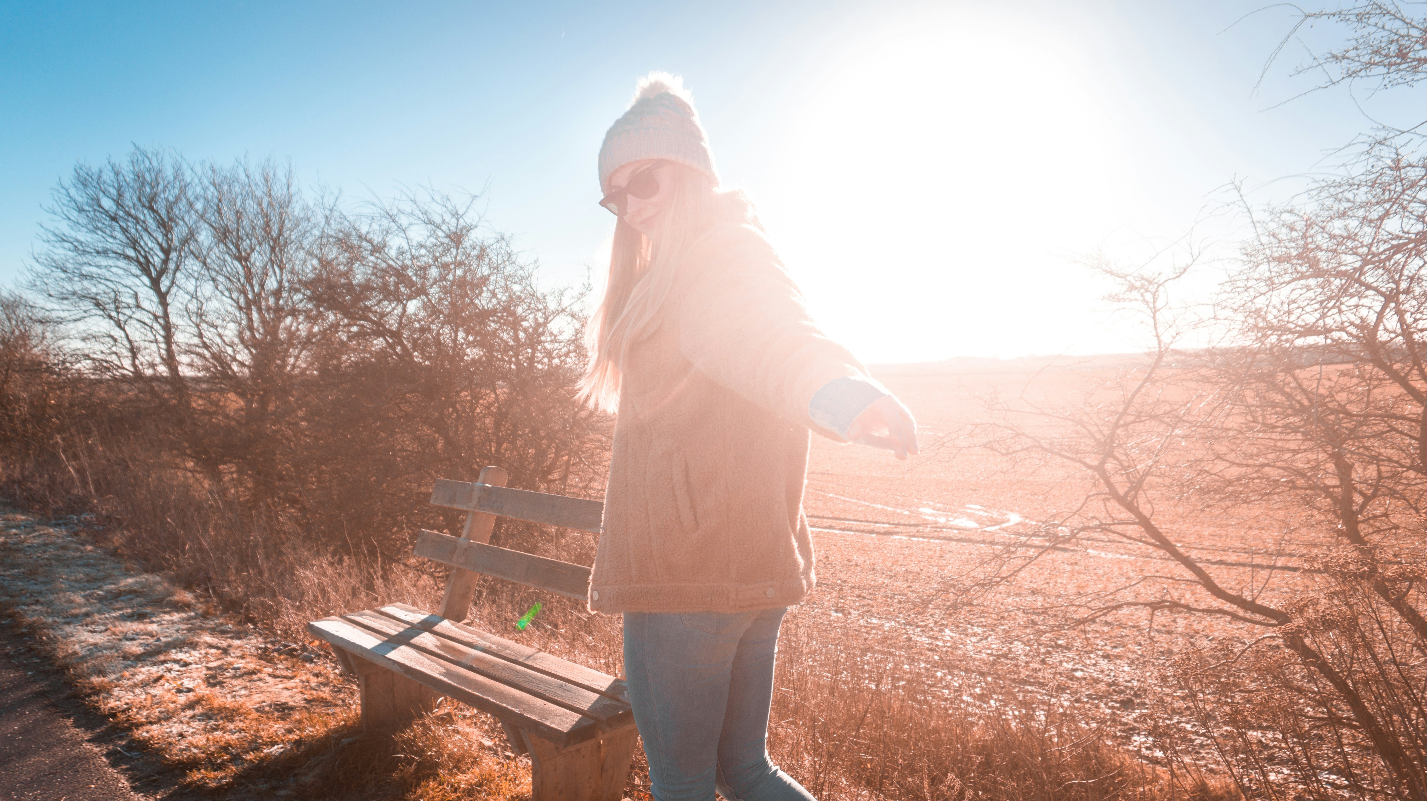 woman wearing brown coat near bench, 