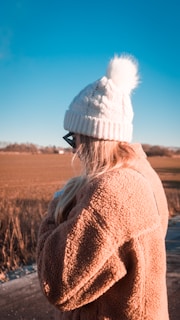 A model wearing a proud britannia hat and scarf in a scenic outdoor setting.