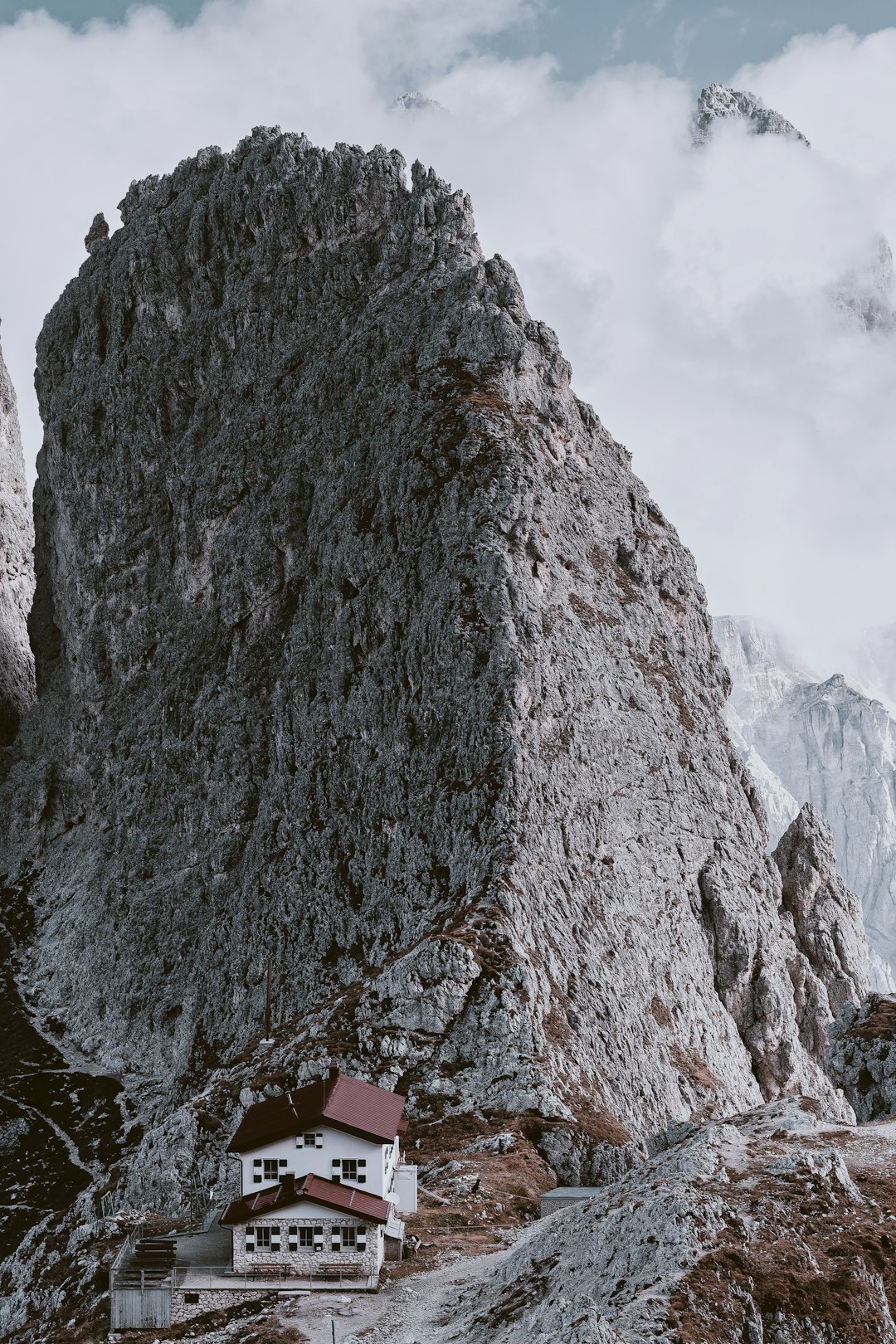 white 2-story house beside mountain cliff during daytime