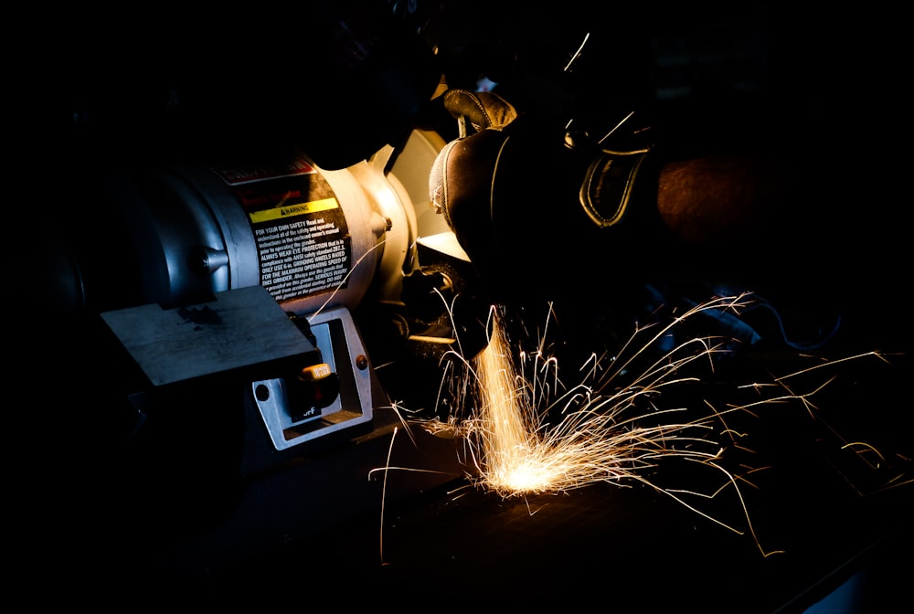 person using bench grinder