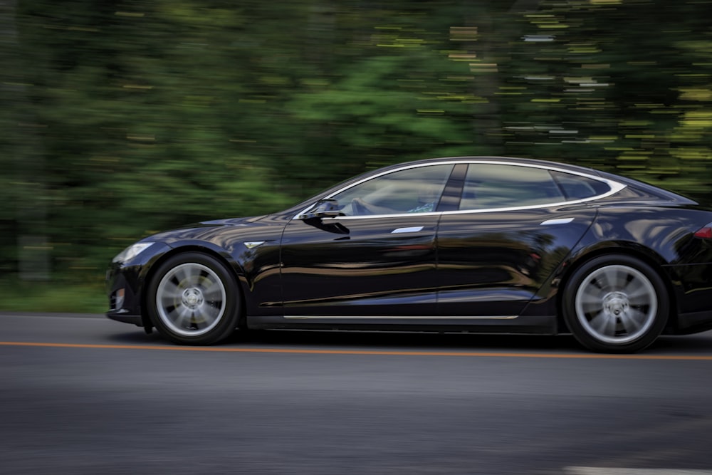 black sedan on gray concrete road