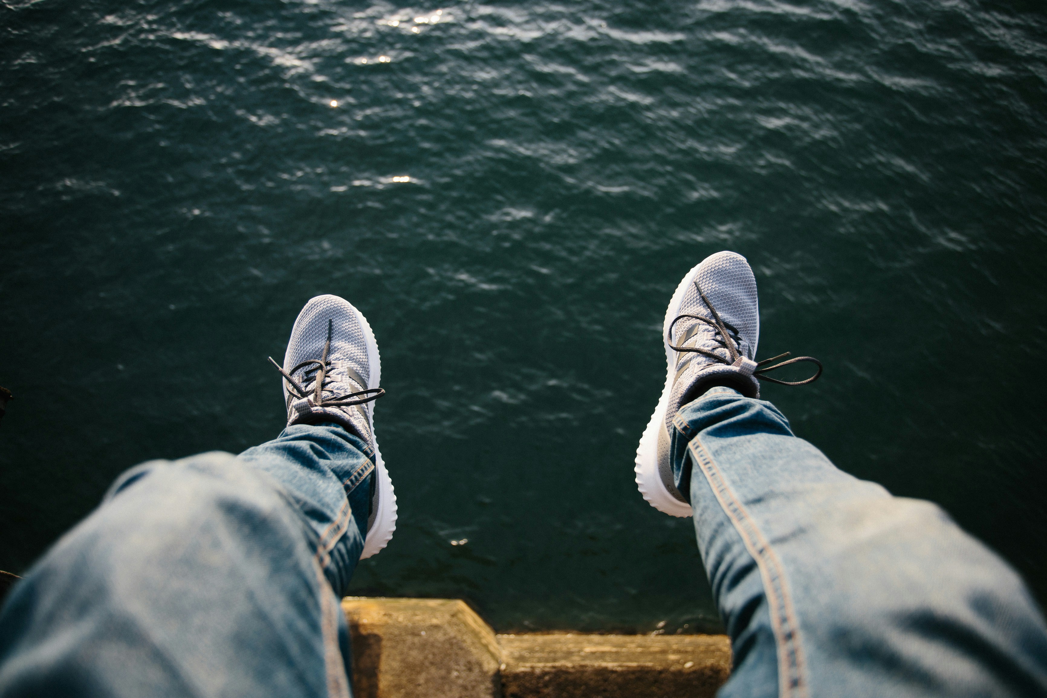 person sitting near body of water
