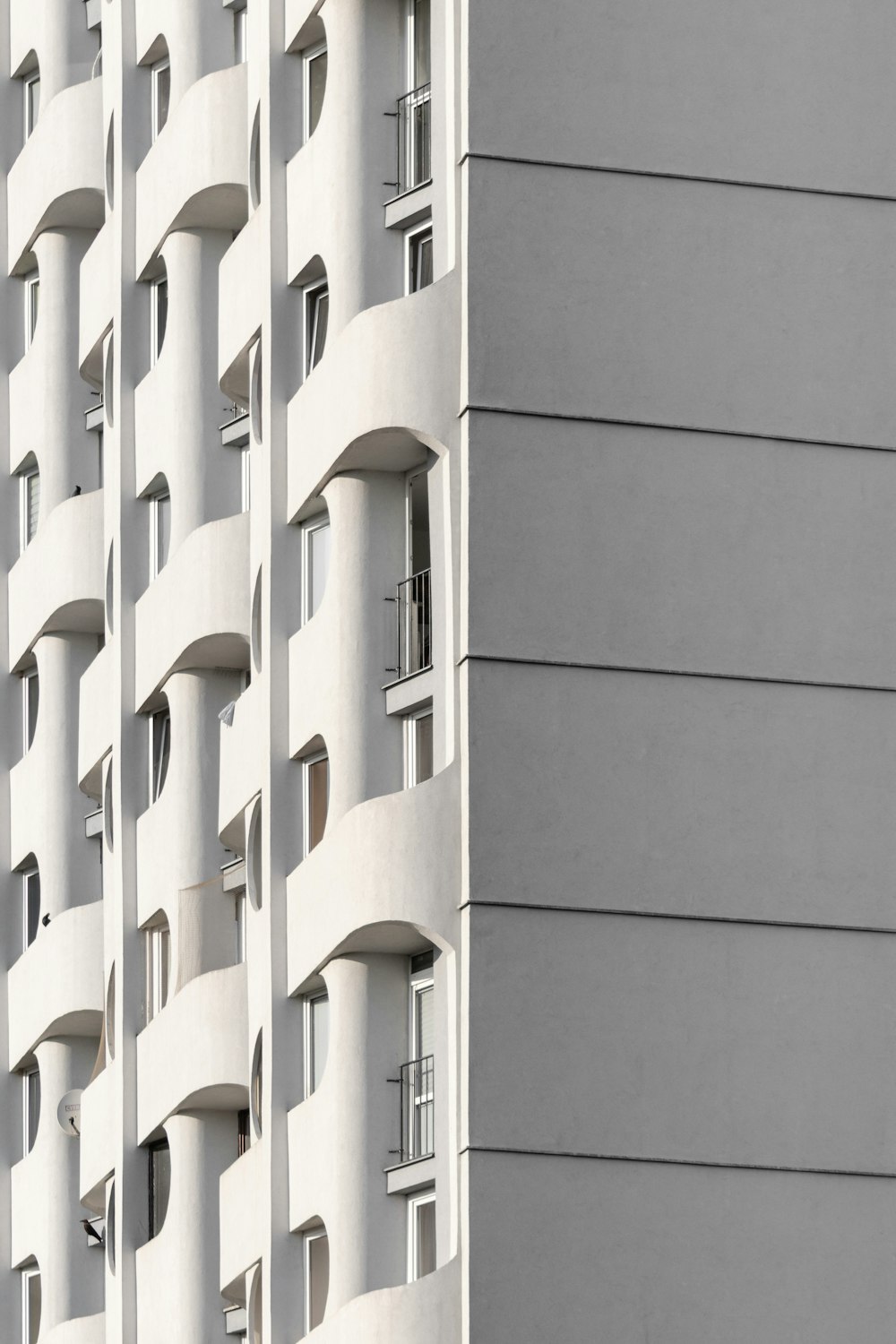 a tall white building with lots of windows