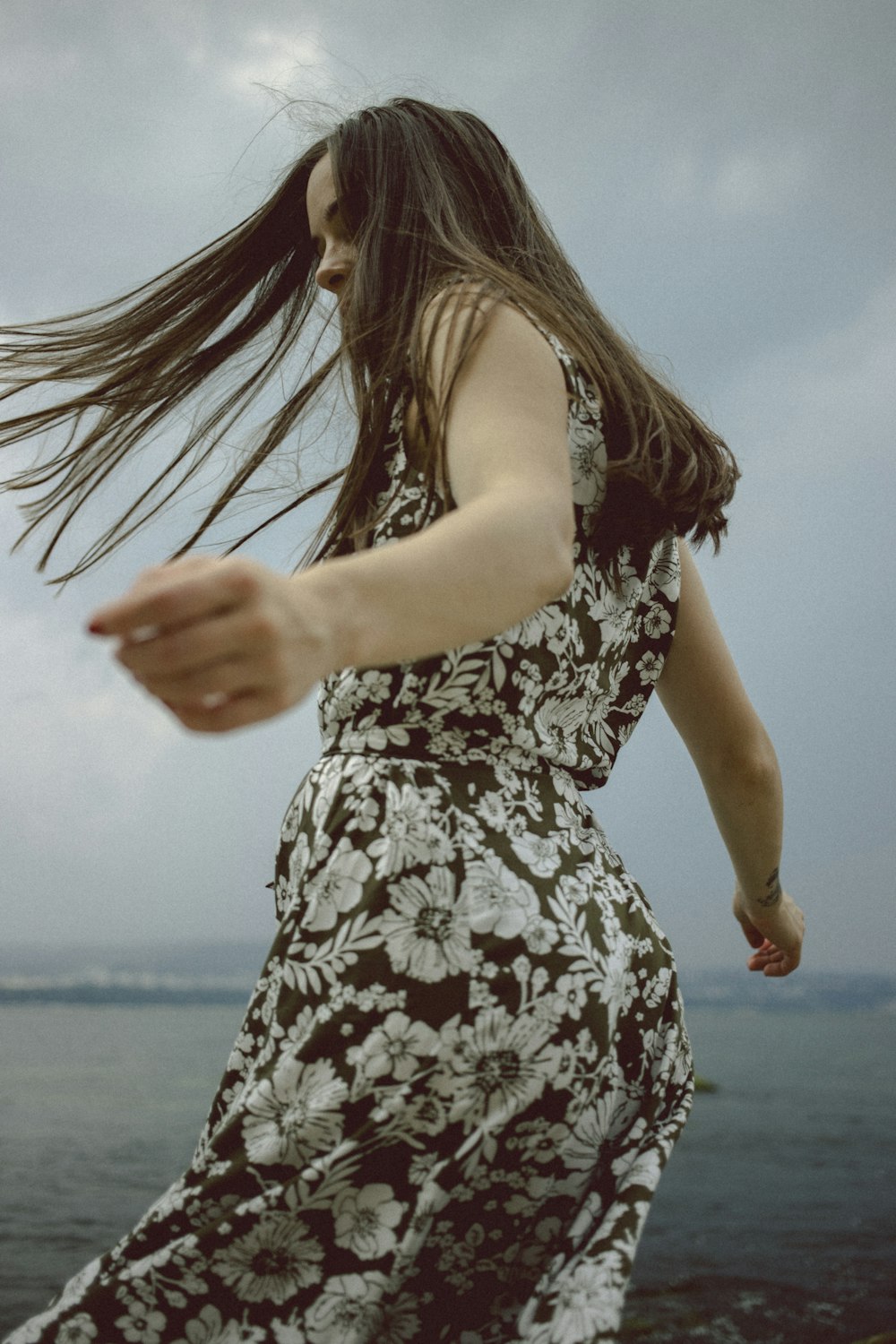 woman in brown and white floral sleeveless top and pants