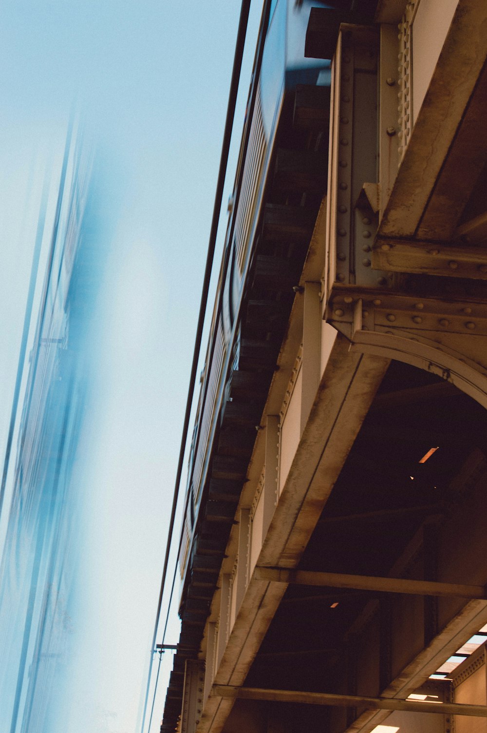 a train traveling over a bridge next to a tall building