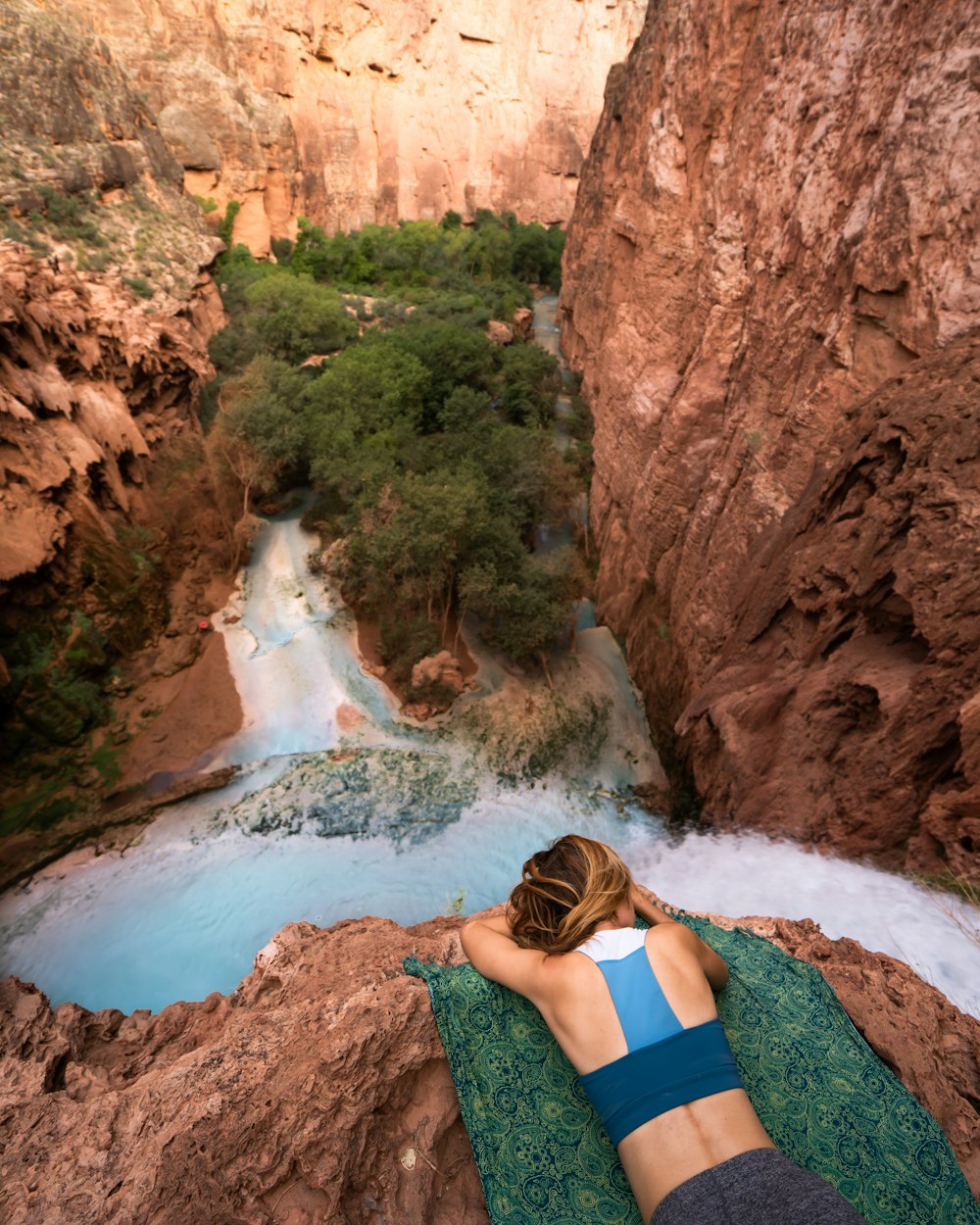 woman facing down on water falls