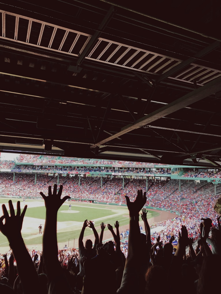 people watching baseball game during daytime