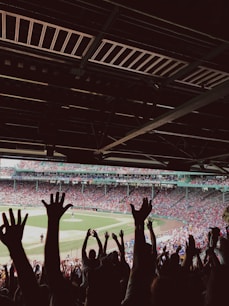 people watching baseball game during daytime