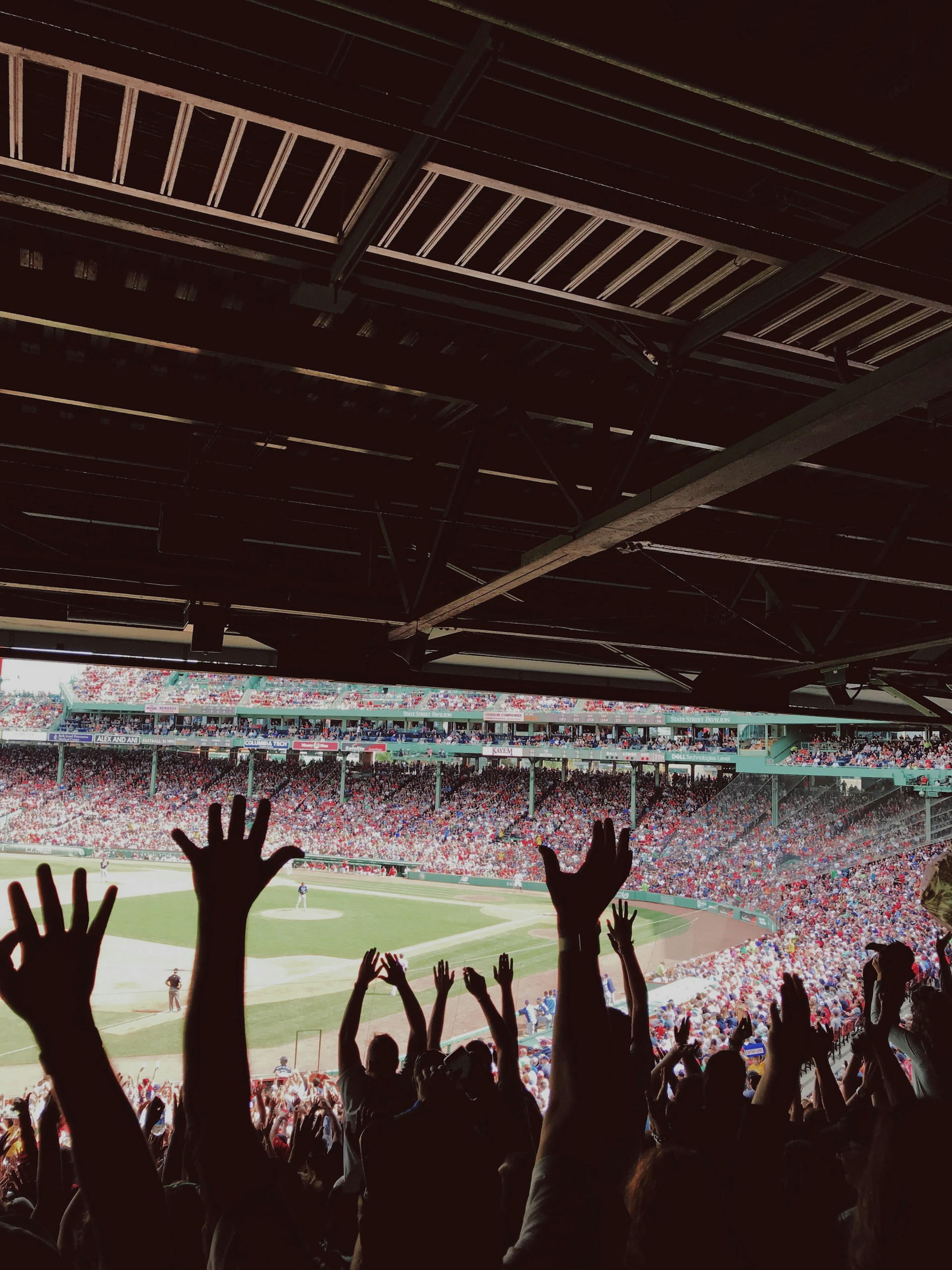 people watching baseball game during daytime