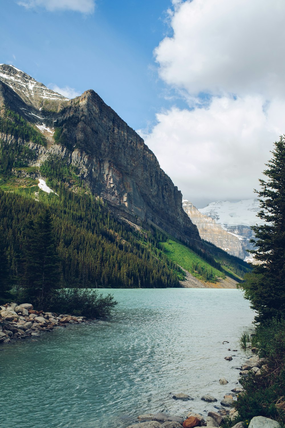 aerial photography of mountain beside body of water at daytime