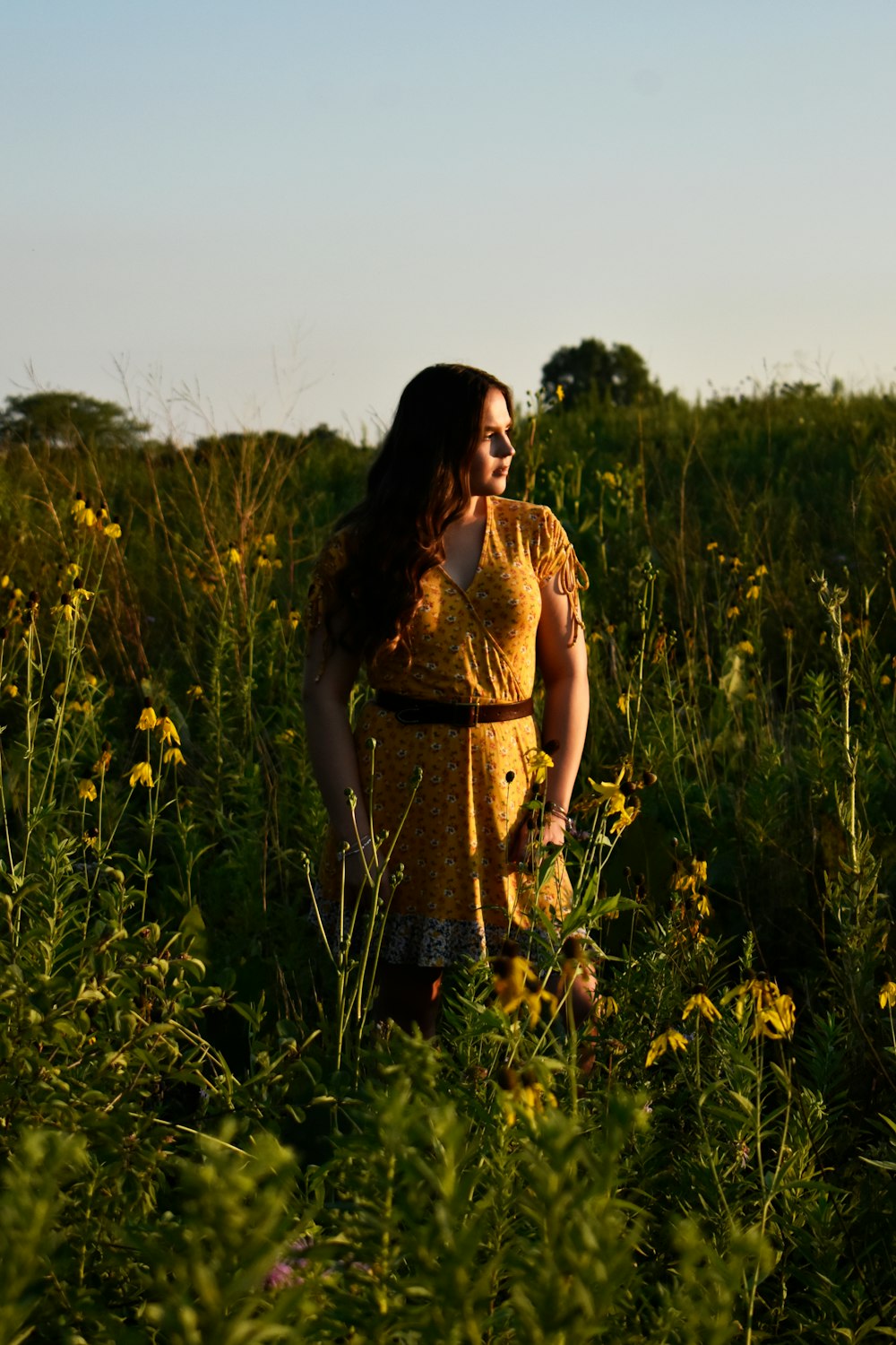 woman standing beside grass field