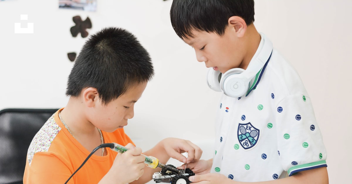 Boy soldering car toy white sitting on chair photo – Free Human Image ...