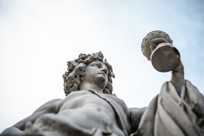 woman holding goblet statue