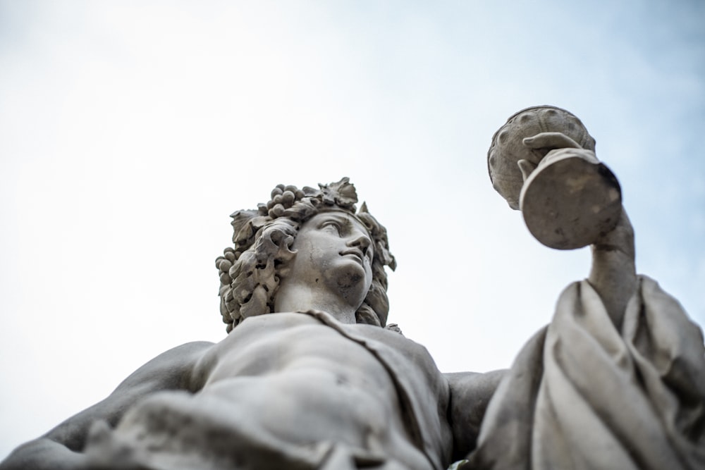 woman holding goblet statue