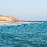 people riding surfboards in ocean at daytime