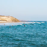 people riding surfboards in ocean at daytime
