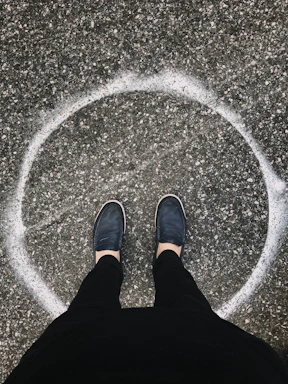 person in black pants and shoes