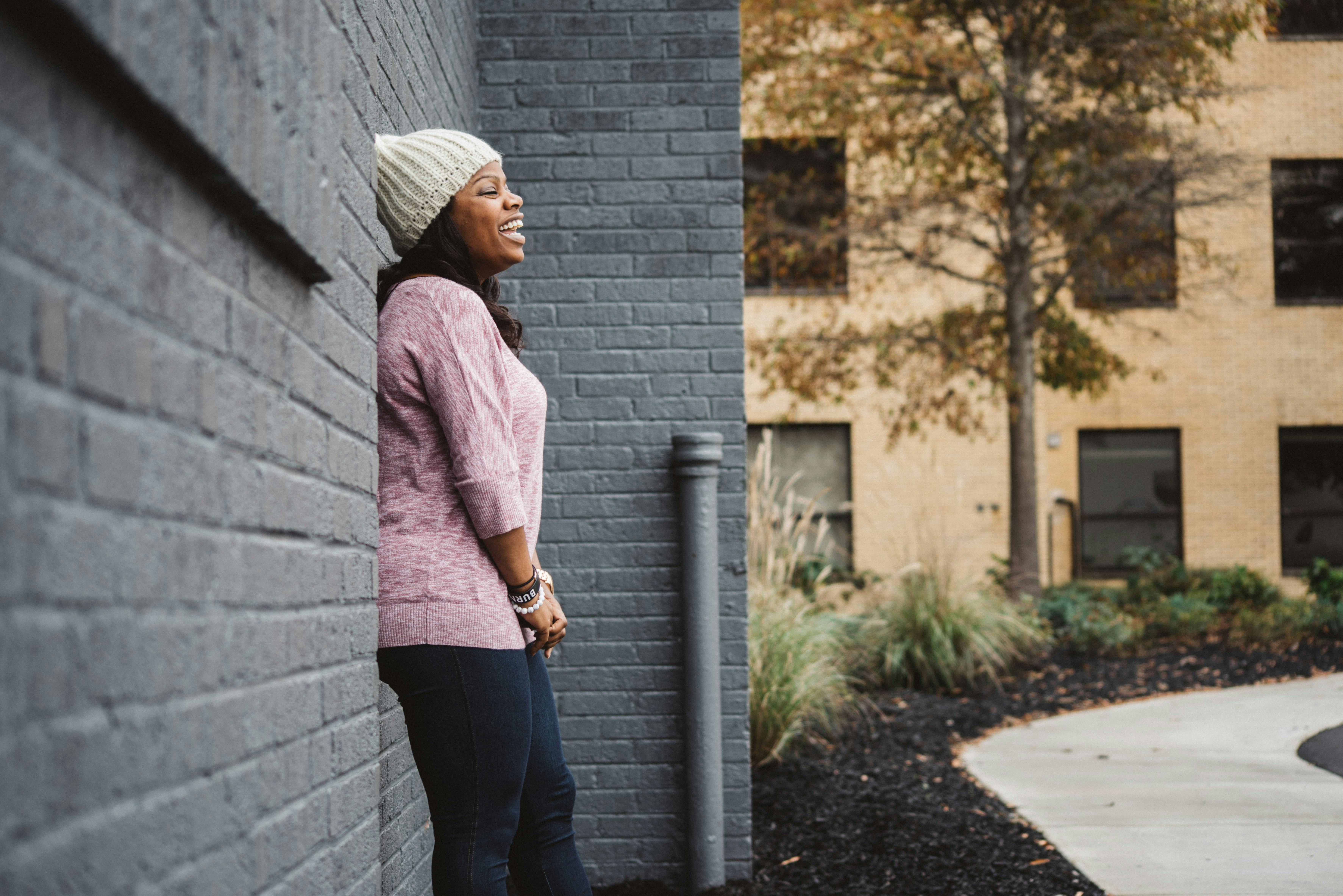 standing woman leaning on wall