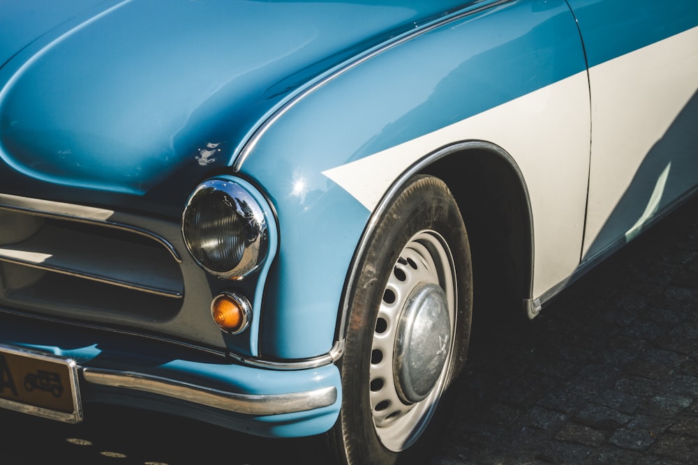 closeup photo of blue and white car